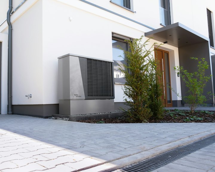 A heat pump outside a modern house